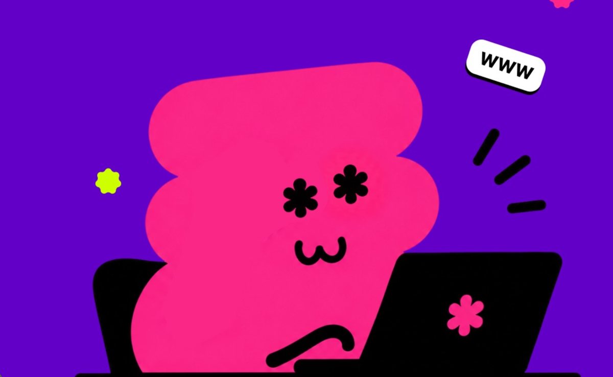 Nuestro personaje rosado con ojos de estrella trabajando en una laptop, junto a un letrero www